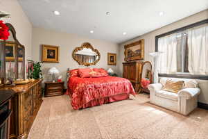 Bedroom with light colored carpet