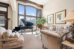 Carpeted living room with a high ceiling