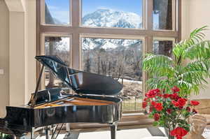 Misc room featuring a mountain view and a towering ceiling