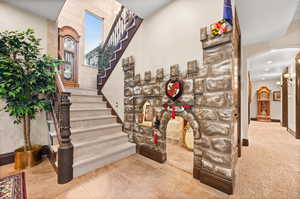 Staircase featuring light tile flooring