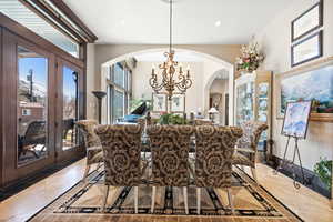 Dining room with light tile floors and a chandelier