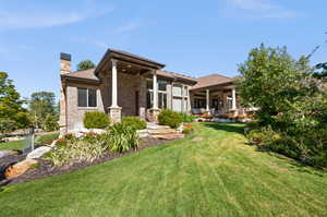 Rear view of house featuring a yard