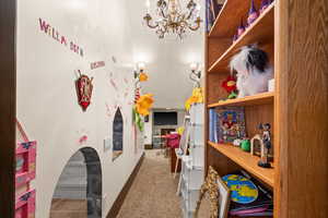 Interior space with light carpet and a chandelier