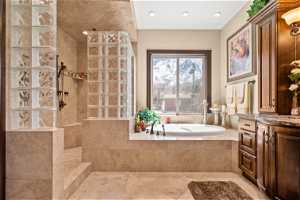 Bathroom featuring vanity, separate shower and tub, and tile floors