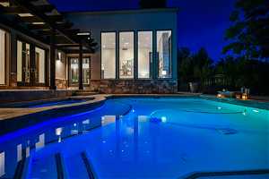 Pool at night with french doors