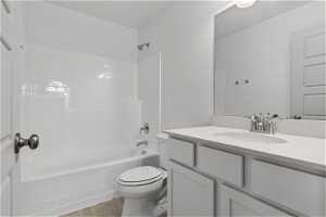 Full bathroom featuring tile floors, bathtub / shower combination, vanity, and toilet