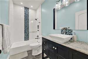 Upstairs / Hall bathroom with vanity, toilet, heated tile floors, and tiled shower / bath