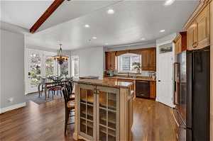 Kitchen featuring granite countertops, gas stove, large pantry, island with gas range.