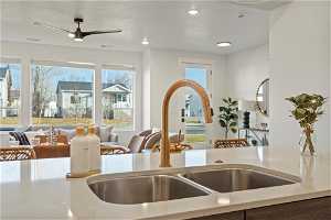 Kitchen featuring a textured ceiling, sink, ceiling fan, and a healthy amount of sunlight