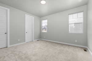 Unfurnished room with light colored carpet