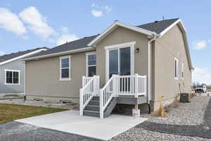 Back of property featuring a patio and central AC unit