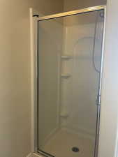 Bathroom with a shower with shower door