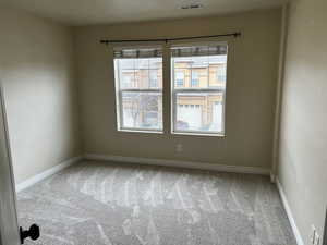 Unfurnished room with light carpet