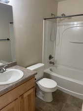 Full bathroom with vanity, toilet, bathtub / shower combination, and tile floors