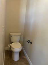 Bathroom with tile flooring and toilet