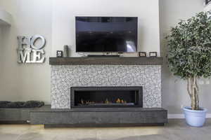 Room details with tile flooring and a tile fireplace