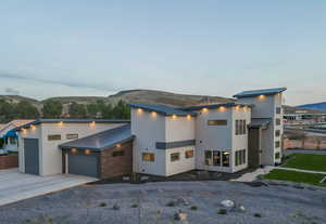 Contemporary home featuring a garage and a mountain view