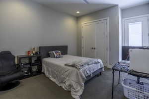 Bedroom featuring a closet and dark colored carpet