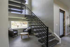 Staircase featuring a towering ceiling