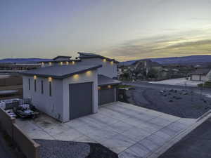 Property exterior at dusk featuring a garage