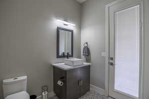 Bathroom featuring tile flooring, vanity, and toilet