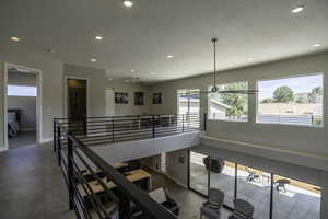 Interior space with dark tile flooring and a chandelier