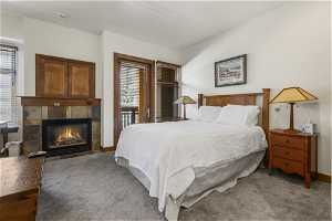 Carpeted bedroom with a fireplace