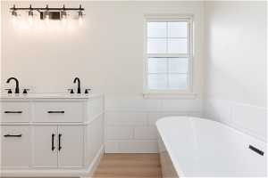 Bathroom featuring plenty of natural light, sink, and hardwood / wood-style flooring