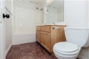 Full bathroom with  shower combination, tile flooring, vanity, and toilet