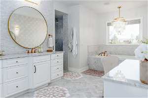 Bathroom with an inviting chandelier, vanity, a relaxing tiled bath, tile floors, and backsplash