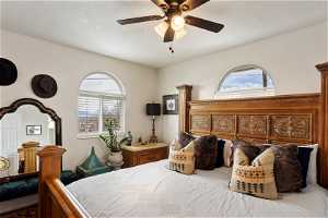 Bedroom with multiple windows and ceiling fan