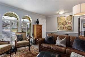 Carpeted living room featuring ornamental molding