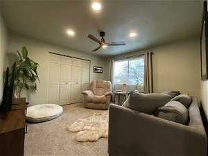 South unit bedroom featuring ceiling fan and carpet