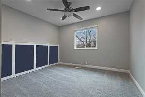 North unit Carpeted room with ceiling fan