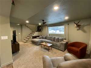 South unit Carpeted living room with ceiling fan and a textured ceiling