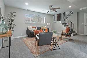 North unit Living room with ceiling fan and carpet flooring