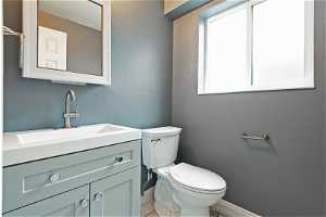 North unit Bathroom with toilet, tile floors, and oversized vanity