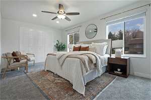 North unit Bedroom featuring a closet, ceiling fan, and carpet