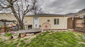 Back of property with a lawn and a deck