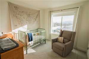 Carpeted bedroom with a nursery area