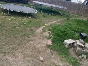 View of yard with a trampoline
