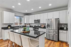 Kitchen featuring a breakfast bar area, stainless steel appliances, and a center island