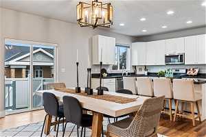 Semi-formal dining area featuring a chandelier and light hardwood / wood-style flooring