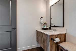 Bathroom with hardwood / wood-style flooring and oversized vanity