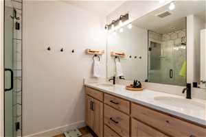 Bathroom with double vanity and walk in shower