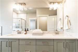 Bathroom featuring double vanity and walk in shower