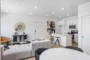 Living room featuring sink and light wood-type flooring