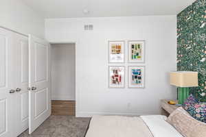 Carpeted bedroom with a closet