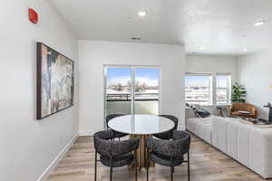 Dining room with light hardwood / wood-style flooring