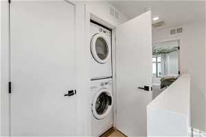 Laundry room featuring stacked washing maching and dryer